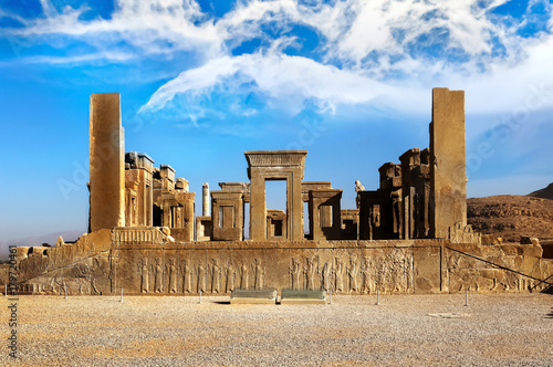 Persepolis is the capital of the ancient Achaemenid kingdom. Sight of Iran. Ancient Persia. Blue sky and clouds background.