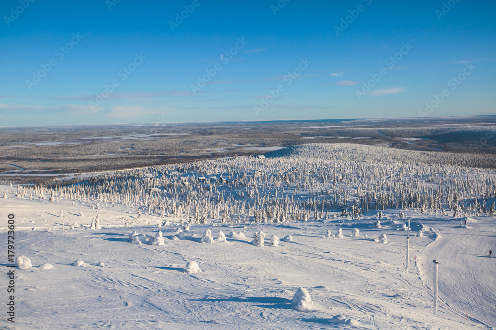 Beautiful cold mountain view of ski resort, sunny winter day with slope, piste and ski lift