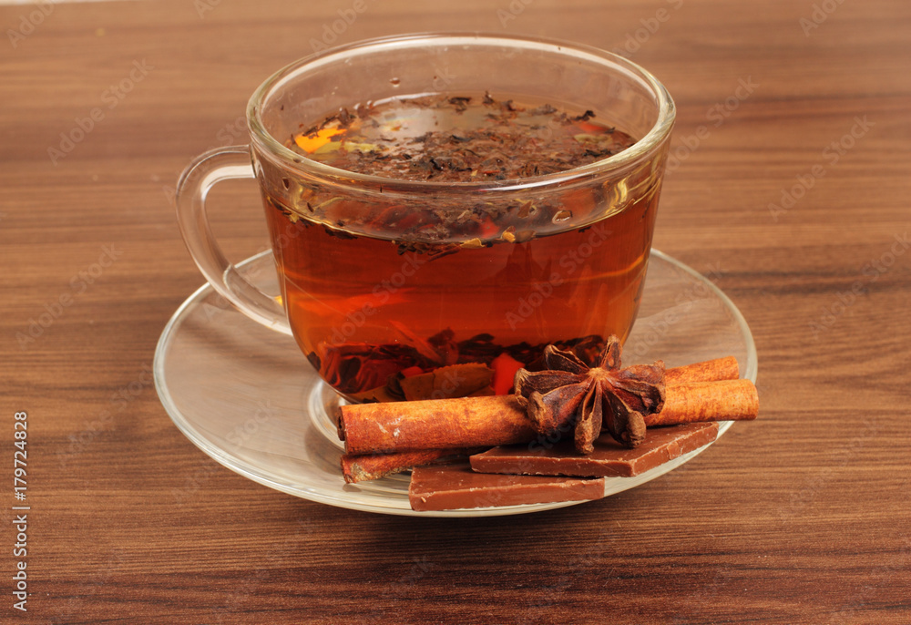 Tea Cup on a saucer, chocolate, cinnamon,sea buckthorn , on a white background Tea Cup on a saucer, chocolate, cinnamon,sea buckthorn , on a white background