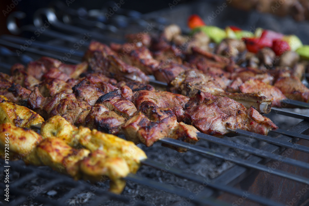 Different kinds of meat and vegetables on skewers