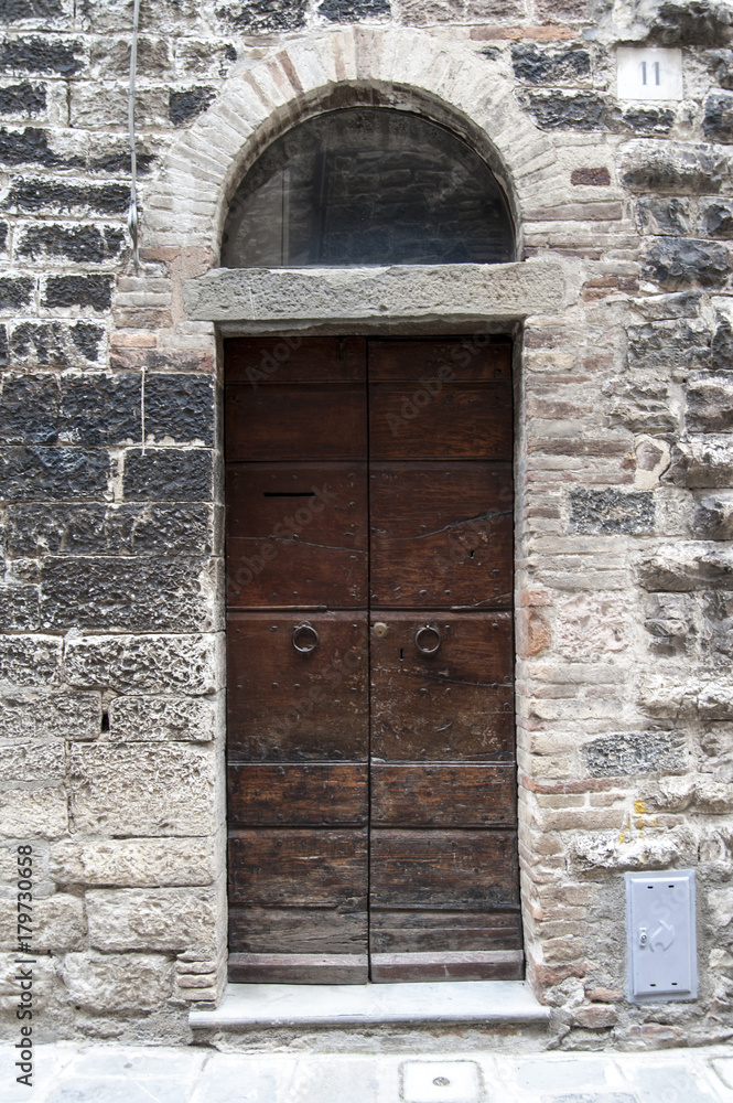 Gubbio, Perugia, Italy -  entrance door, architectural details of the ancient palaces