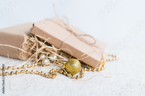 Christmas gifts next to Christmas toys and gold beads