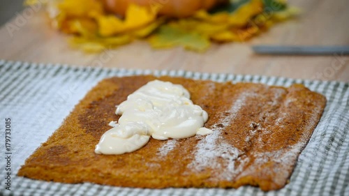 Cooking Pumpkin roll with the cream. photo