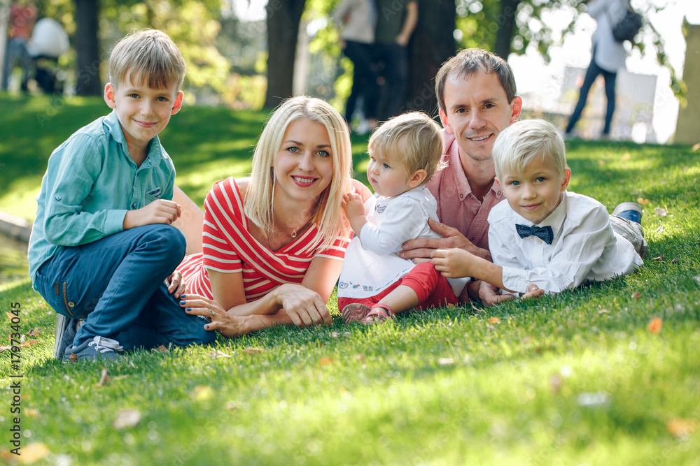 Happy young family with three children outdoors
