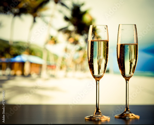 two champagne glasses on the beach - exotic New Year