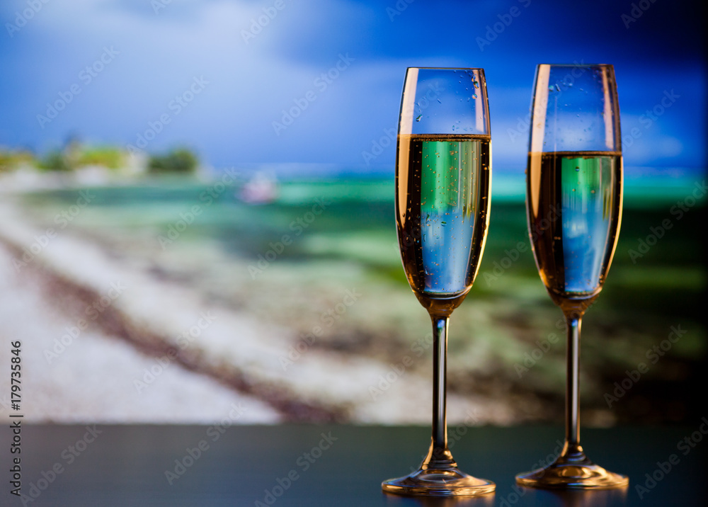 two champagne glasses on the beach - exotic New Year
