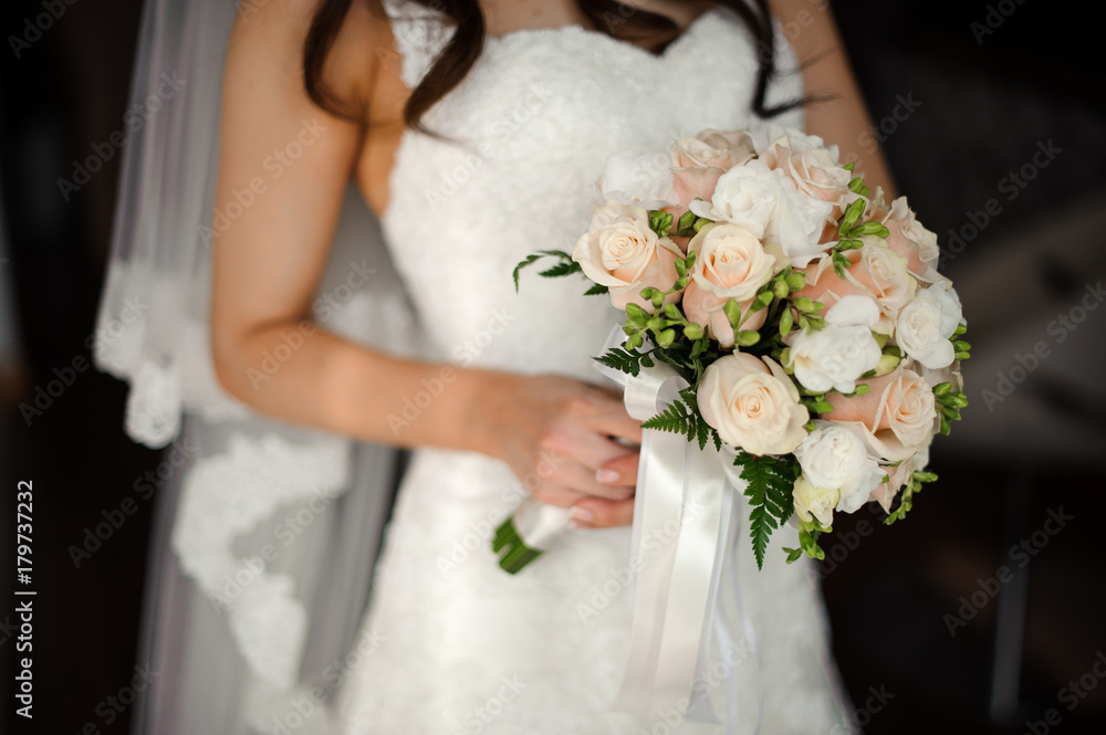 Bride in a beautiful white dress holding a bouquet