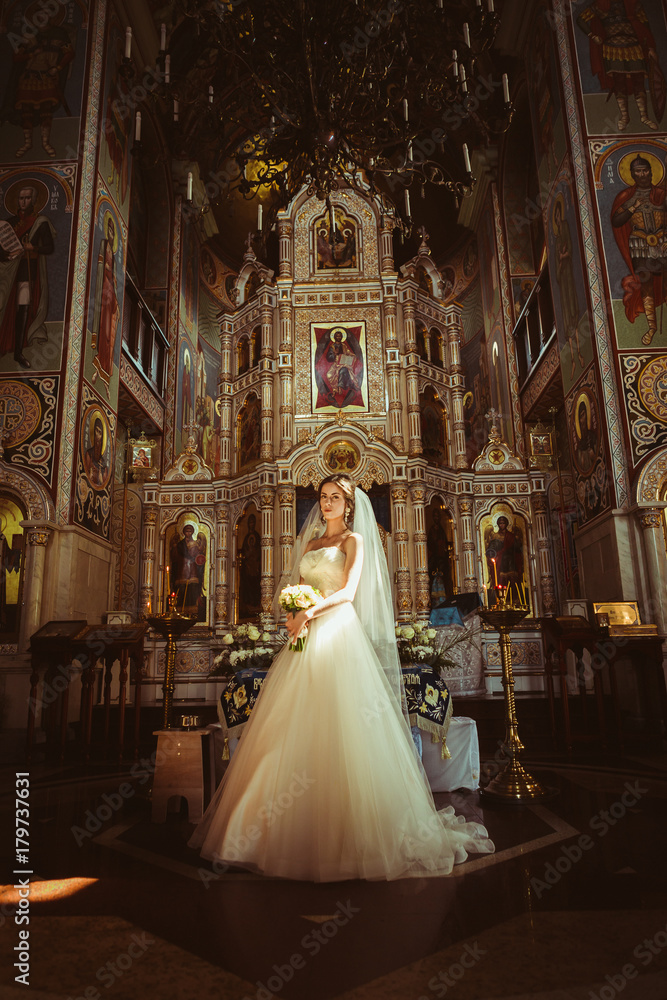 Stylish elegant bride on background the old church