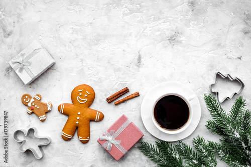 Coffee with gingebread cookies and gifts in christmas evening. Grey stone background top view copyspace photo