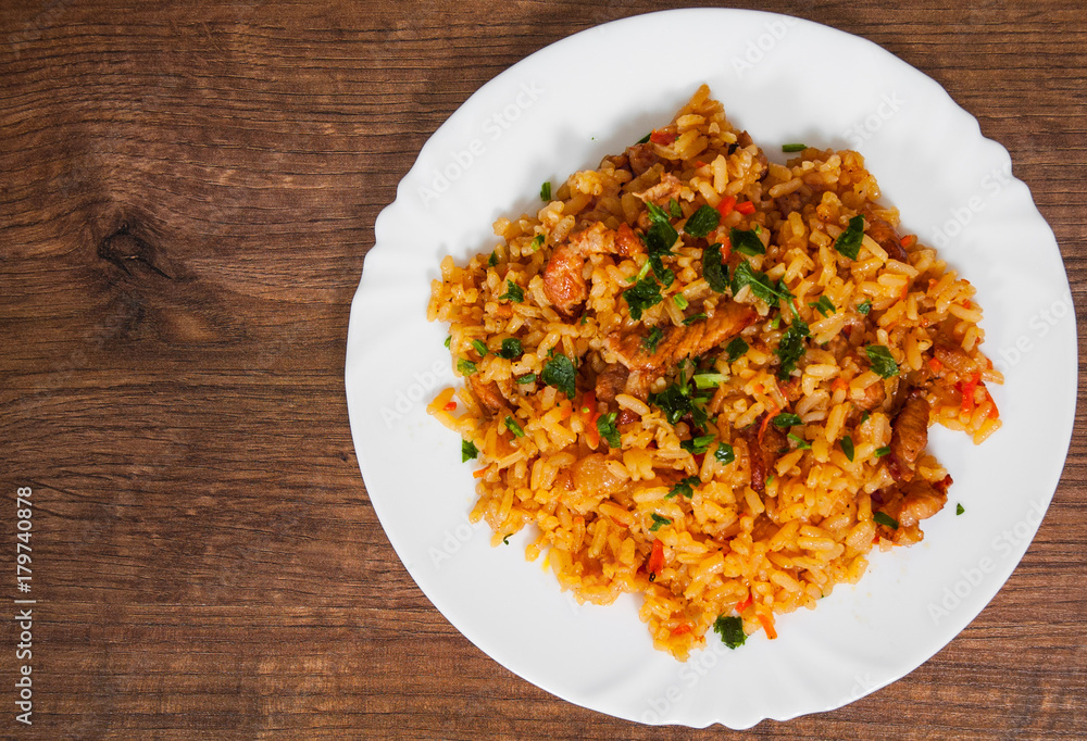 Rice with Vegetables and Meat in a plate on wooden table. with copy space. top view Rice with Vegetables and Meat in a plate on wooden table. with copy space. top view