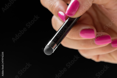 Female hand holding a pen close up