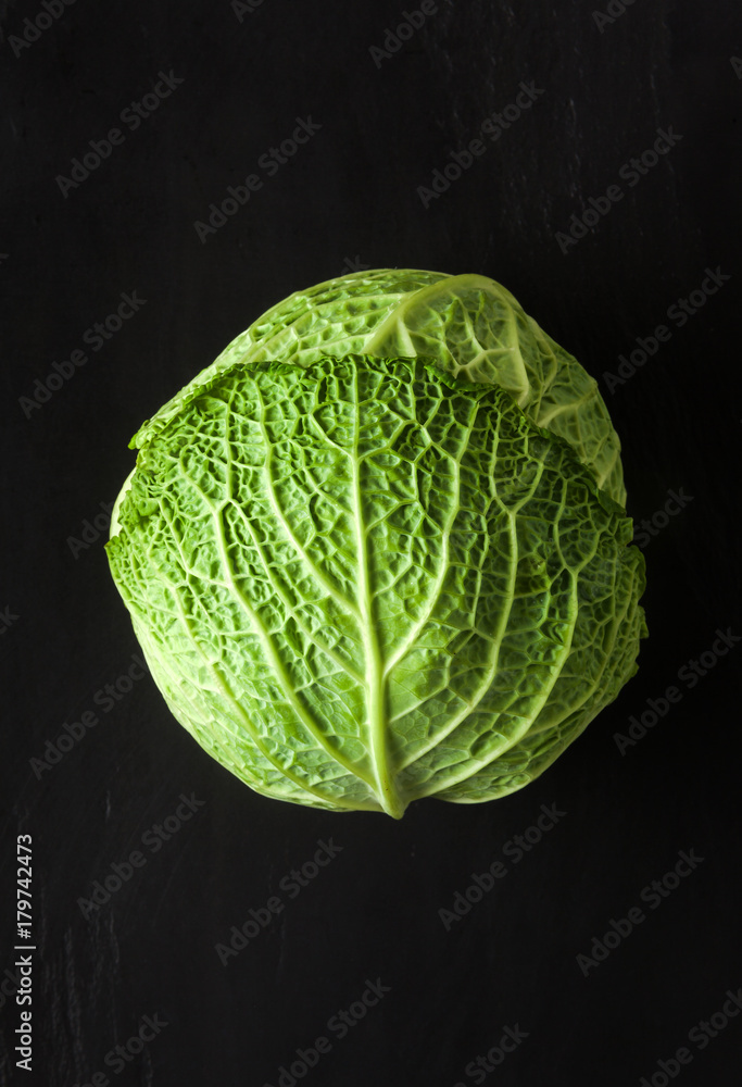 Fototapeta premium Savoy cabbage isolated on black