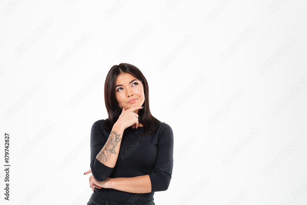 Thoughtful young asian lady standing isolated Thoughtful young asian lady standing isolated