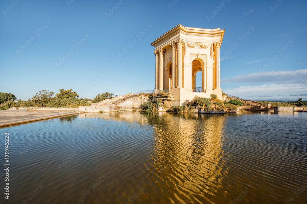 View on the water tower in Peyrou garden with beautiful water reflection during the morning light in Montpellier city in southern France View on the water tower in Peyrou garden with beautiful water reflection during the morning light in Montpellier city in southern France