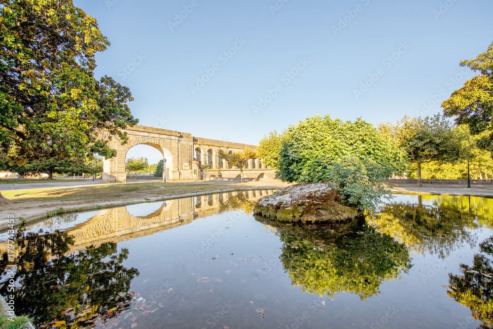 View on the saint Clement aqueduct in Peyrou garden with water reflection during the morning light in Montpellier city in southern France
