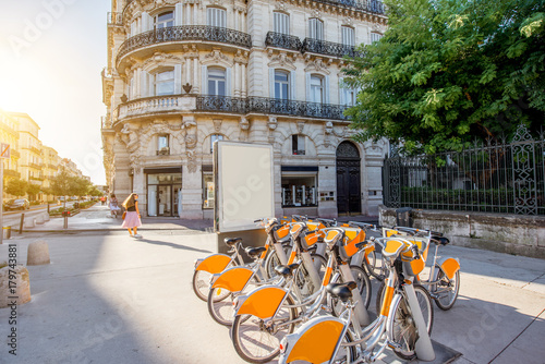 Street view with beautiful old buildings and bicycle parking on the Foch boulevard during the morning light in Montpellier city in France