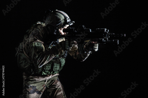 Paratrooper of french 1st Marine Infantry Parachute Regiment RPIMA studio shot firing pointing weapons