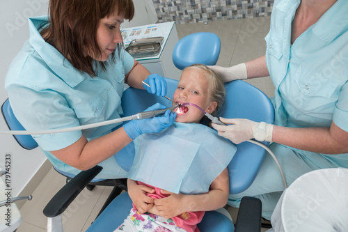 Little girl sitting in the dentists office