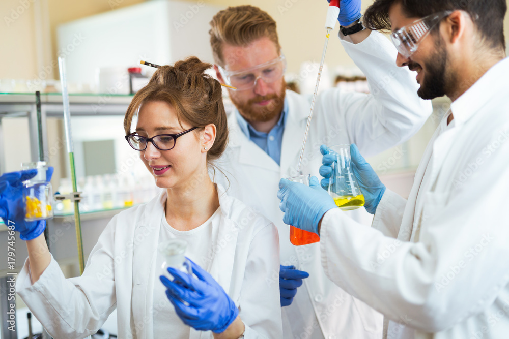 Group of chemistry students working in laboratory Group of chemistry students working in laboratory