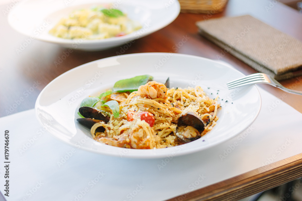 Spaghetti pasta with seafood - mussels and shrimps at italian food restaurant.