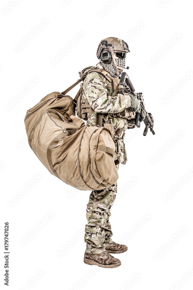 Soldier standing with duffle gym bag studio shot Soldier standing with duffle gym bag studio shot