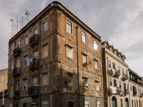 Dilapidated worn classic apartment building facade in city street © Magnus