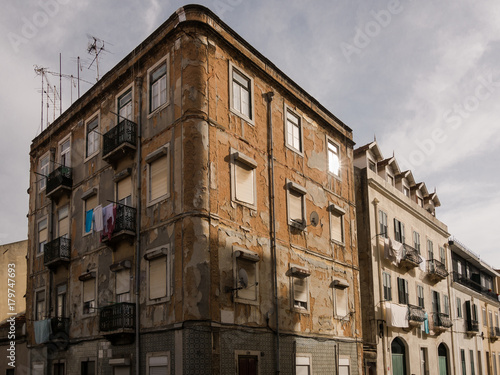 Dilapidated worn classic apartment building facade in city street