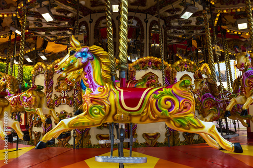 Brightly coloured carousel ponies. © Debu55y