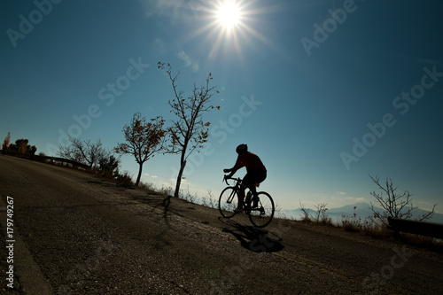 biker silhouette sun uphill in Ioannina Greece