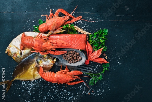 Seafood. Fish Vomer, lobster, salmon. On a wooden background. Top view. Free space for text.