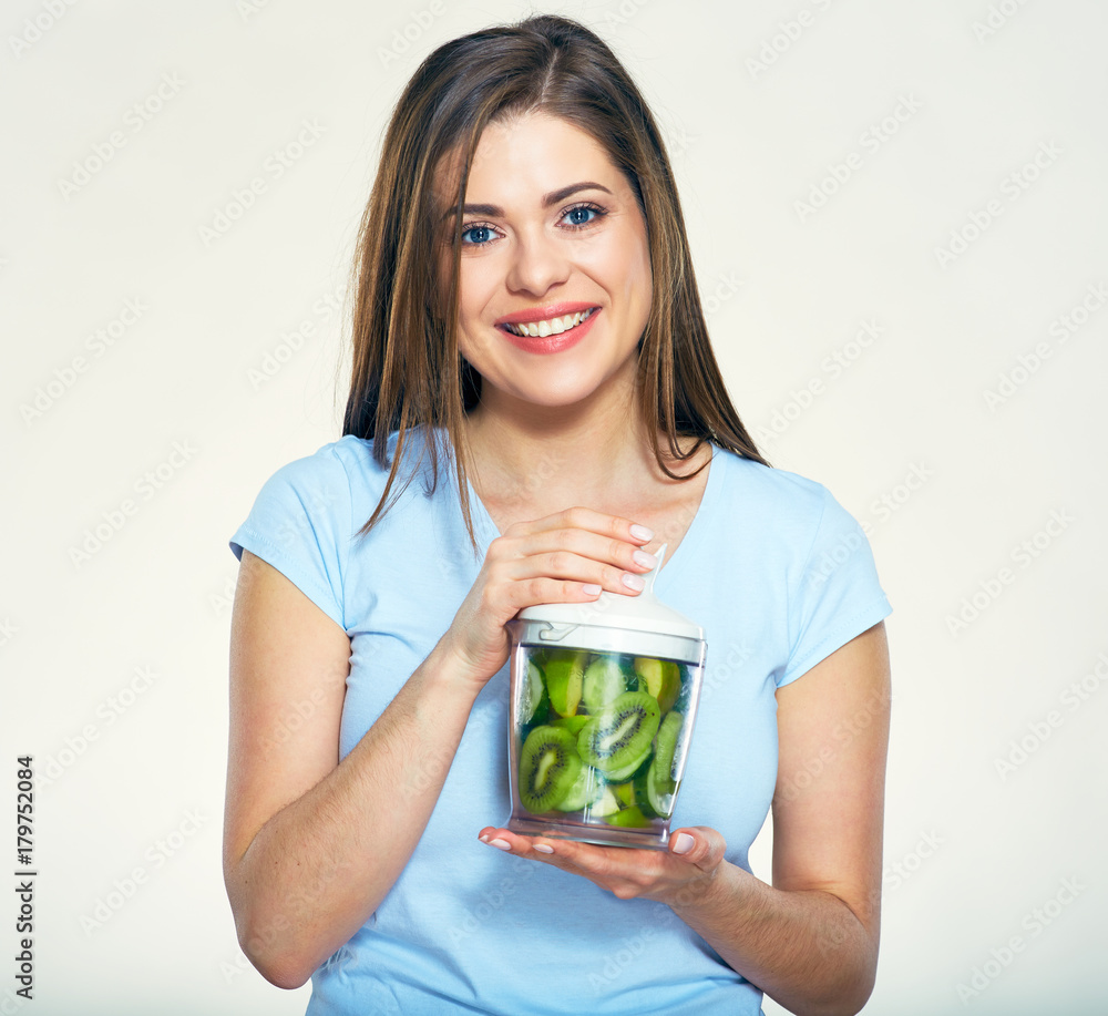 Smiling woman holding blender with smoothy ingredients. Smiling woman holding blender with smoothy ingredients.