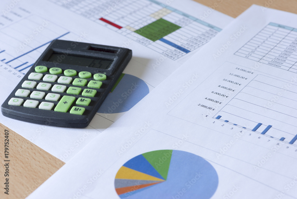 Calculator and accounting documents on a table Calculator and accounting documents on a table