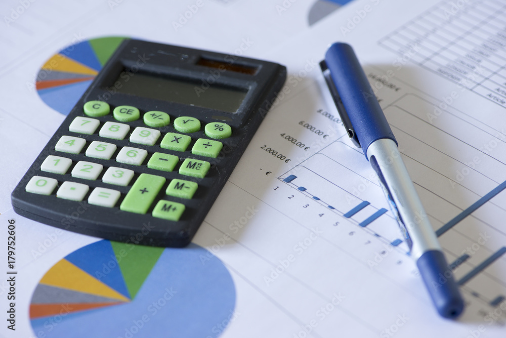 Calculator and accounting documents on a table Calculator and accounting documents on a table