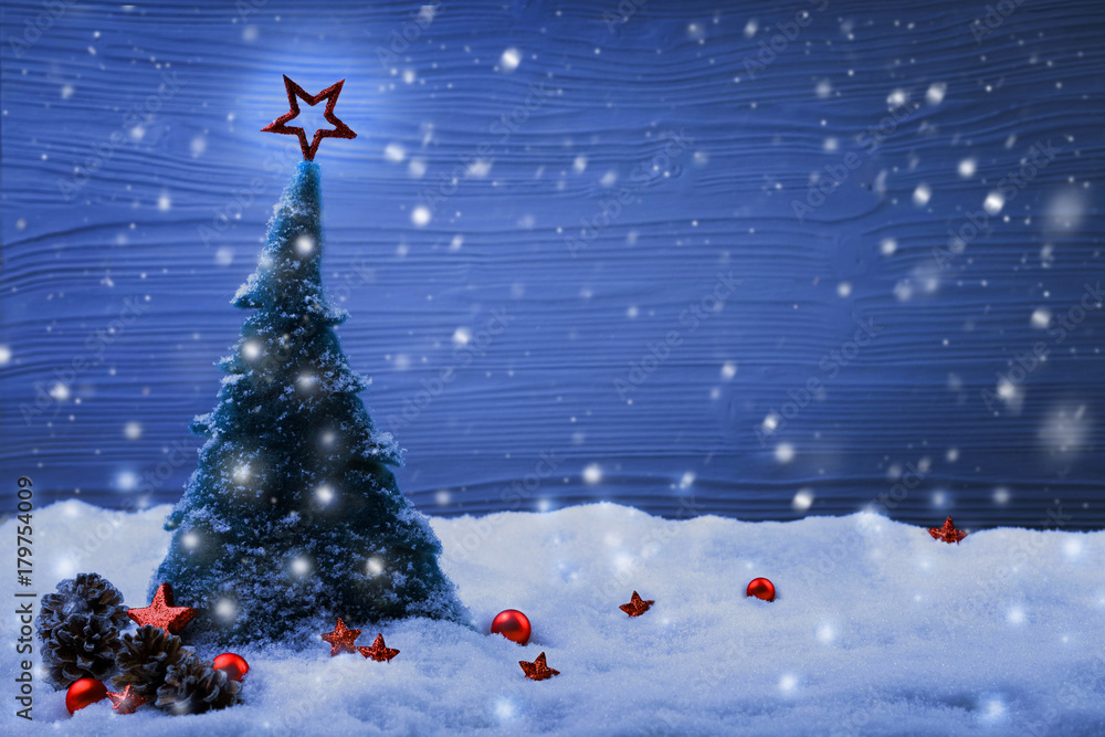 Christmas scene with fir tree in snow landscape and magic lights