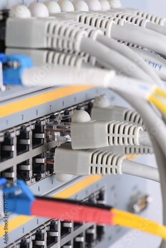 Optic fiber and network cables connected to switch in data center, internet network technology