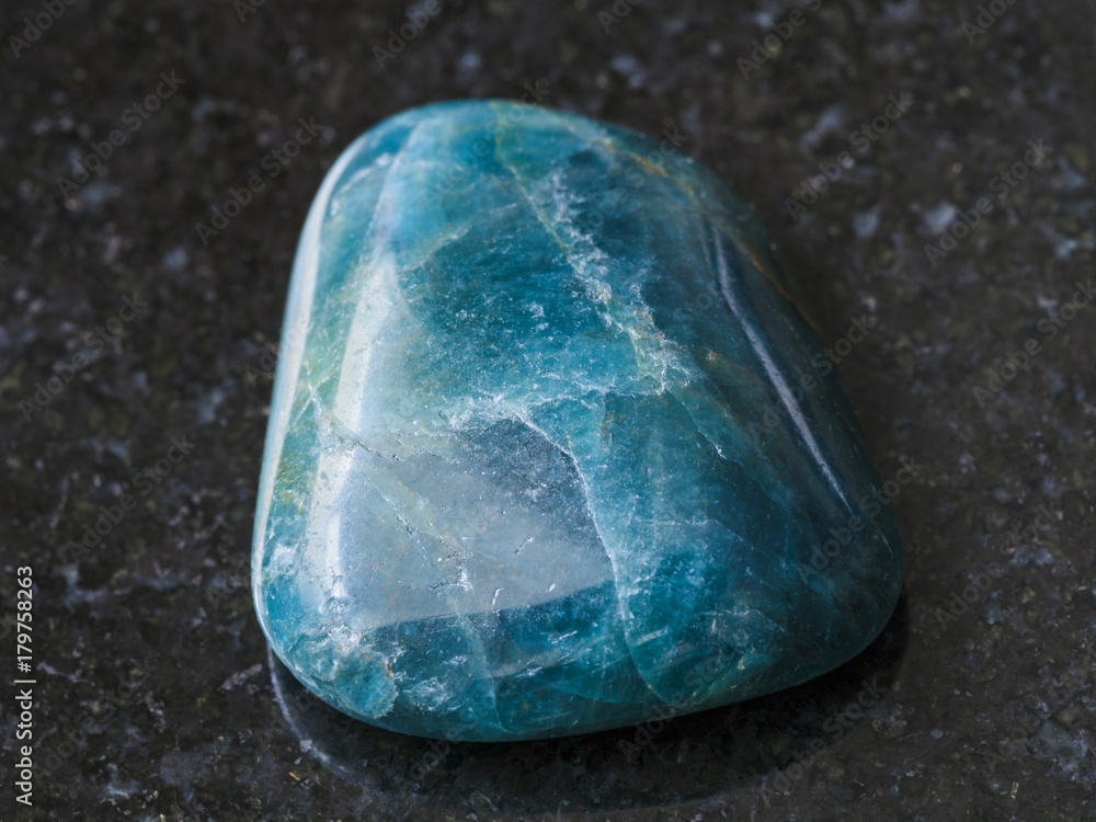 tumbled green blue Apatite gemstone on dark tumbled green blue Apatite gemstone on dark