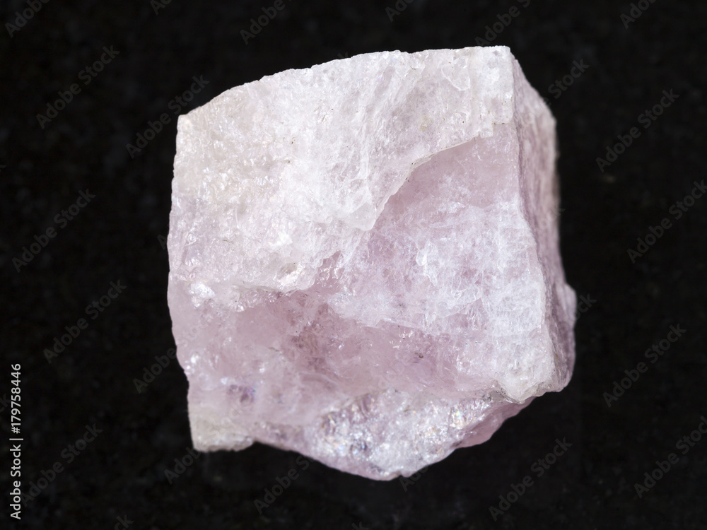 raw crystal of morganite gemstone on dark