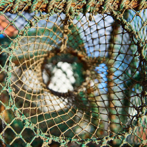 Fishermen's net in various colours with dominating green.