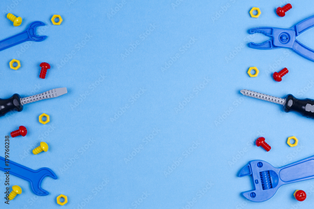 Toys background. Toy tools on blue background. Top view Toys background. Toy tools on blue background. Top view