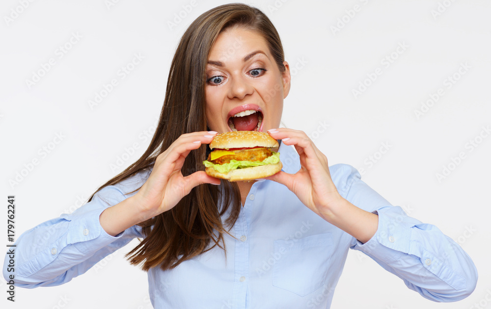 portrait of hungry woman eating burger.