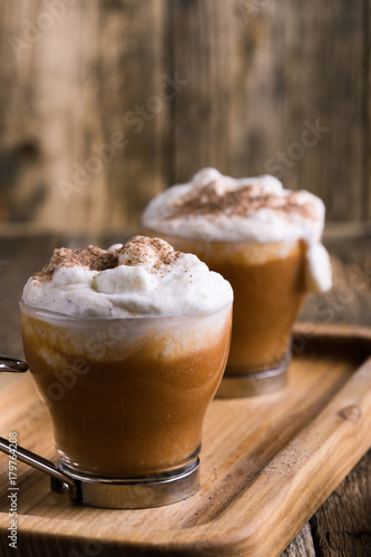 Pumpkin spice latte with whipped cream and pie spices