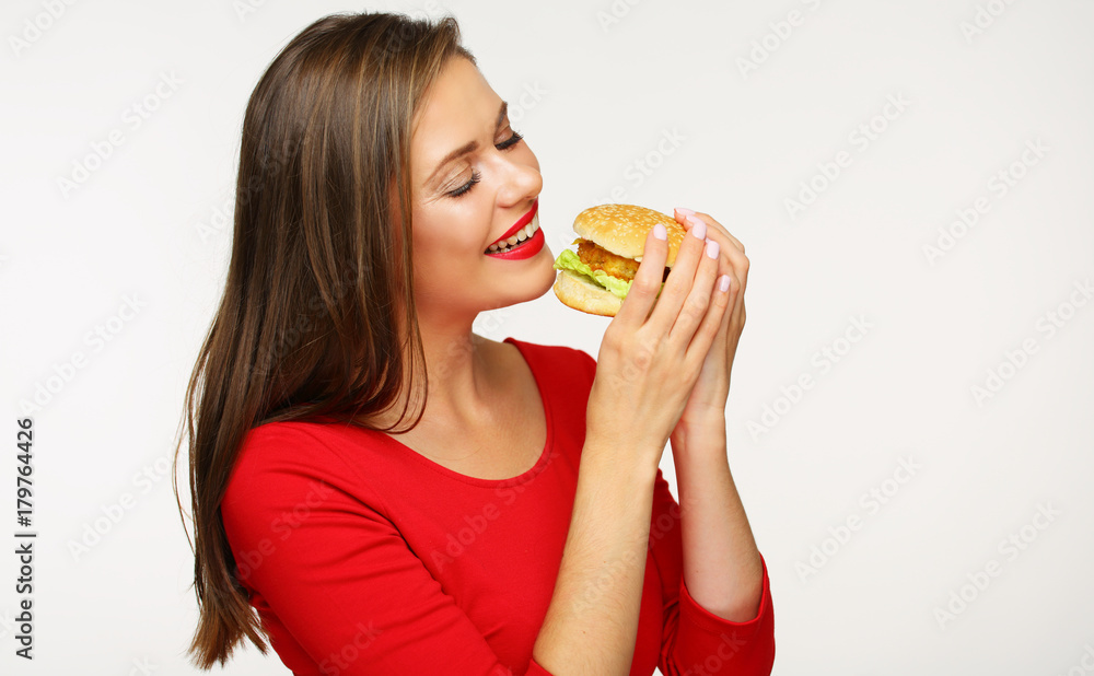 Woman eating burger. Isolated portrait on white Woman eating burger. Isolated portrait on white