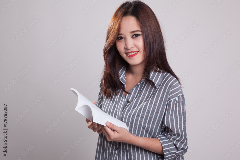 Young Asian woman with a book. Young Asian woman with a book.