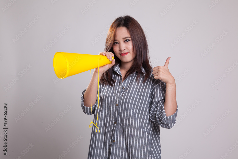 Beautiful young Asian woman show thumbs up announce with megaphone. Beautiful young Asian woman show thumbs up announce with megaphone.