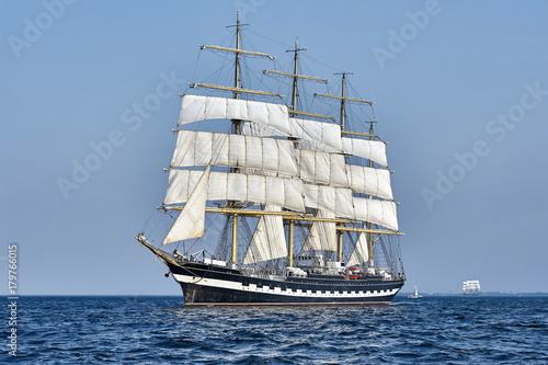  Tall Ship under sail with the shore in the background