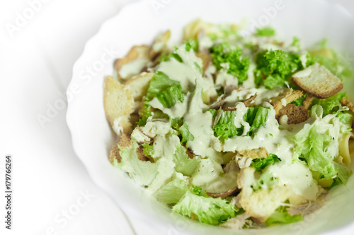Mixed salad with green apple and walnuts on the table
