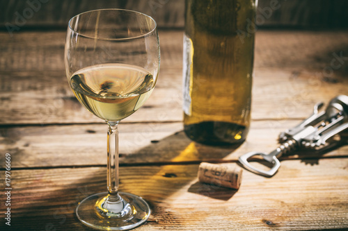 White wine glass on wooden background