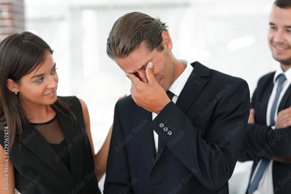 young businessman with tears of joy and his business team young businessman with tears of joy and his business team