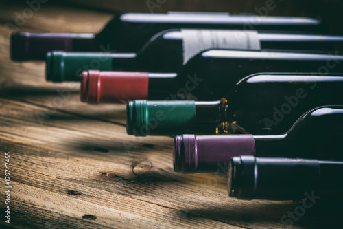 Wine bottles on wooden background © Rawf8