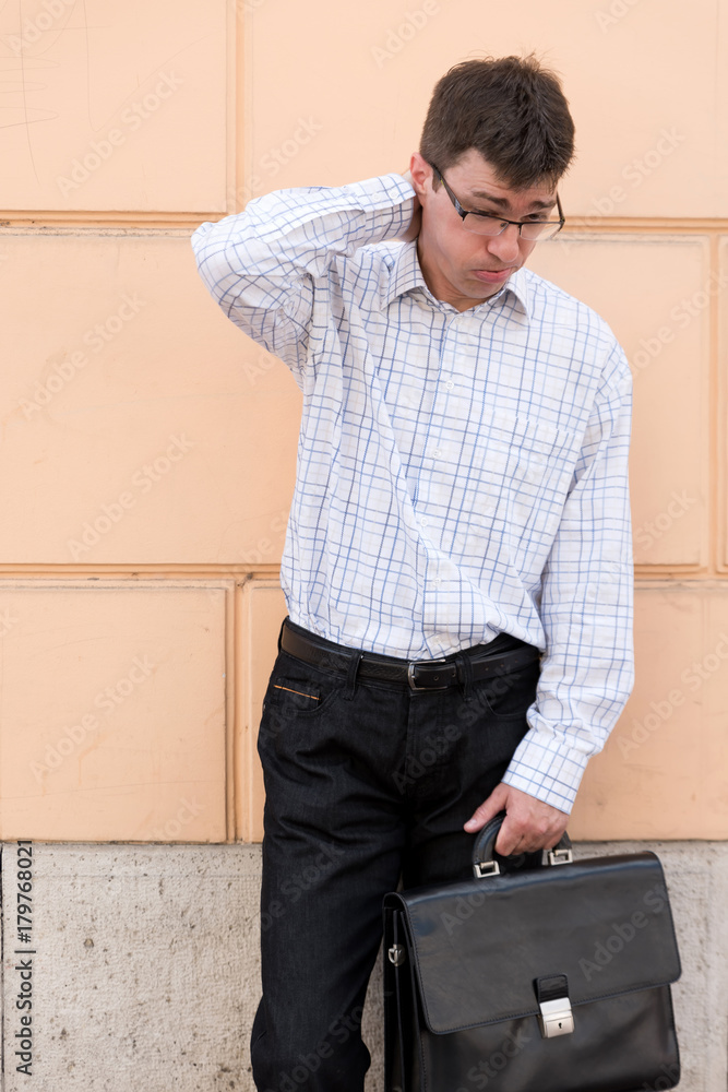 Obraz premium Portrait of a thoughtful and worried business man on the street